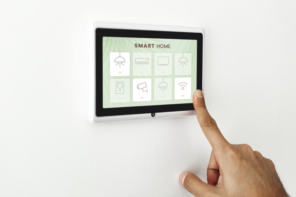 finger pressing on smart home automation panel monitor