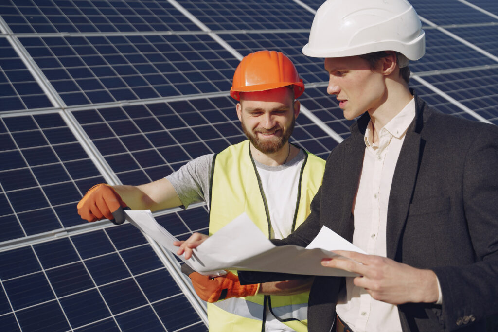 foreman and businessman at solar energy station.